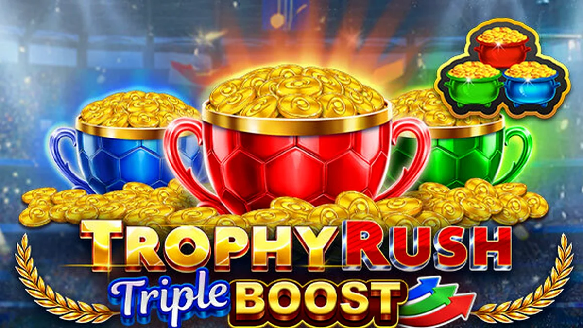 Tampilan layar permainan slot Trophy Rush Triple Boost dengan simbol koin emas dan trofi di bawah sorotan lampu stadion.